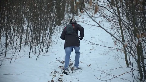 Man running up the hill through the woods at winter Stock-Footage 72194618