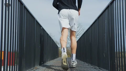 Man running on a metallic bridge Stock Footage 100029243