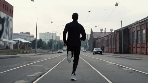 Man running in the middle of the street. Background shot. Slow motion. Abstract Stock-Footage 83464548