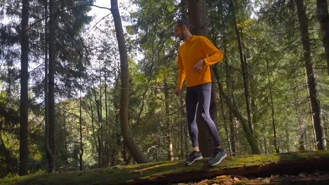 Man running in mountain forest. Trail running Stock Footage 82702469