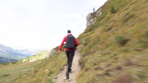 Man running on mountain path on sunny day Stock Footage 143380929