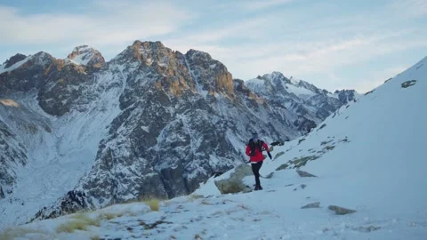 Man running at the mountain with snow Stock Footage 167213782