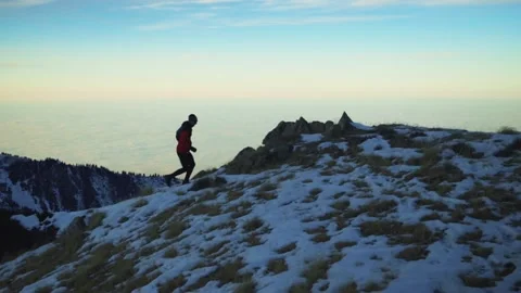 Man running at the mountain with snow Stock Footage 167264100