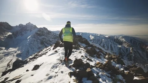 Man running at the mountain with snow Stock Footage 167599828