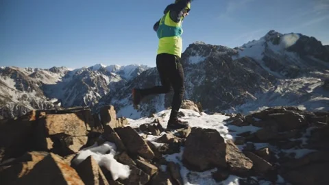 Man running at the mountain with snow Stock Footage 167600512