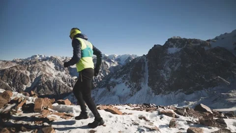 Man running at the mountain with snow Stock Footage 167600533