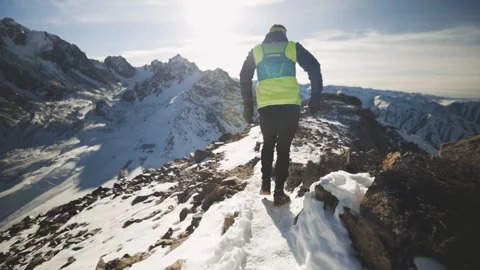 Man running at the mountain with snow Stock Footage 167600719