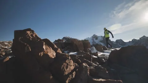 Man running at the mountain with snow Stock Footage 167676252