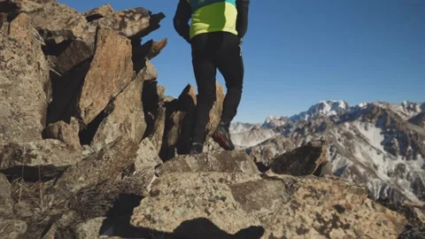 Man running at the mountain with snow Stock Footage 167677030