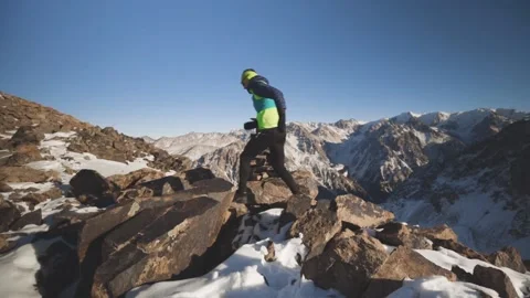 Man running at the mountain with snow Stock Footage 168218106