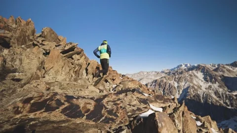 Man running at the mountain with snow Stock Footage 168274377