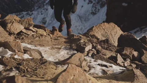 Man running at the mountain with snow Stock Footage 168349745