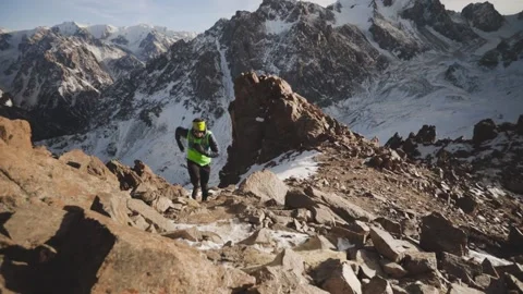 Man running at the mountain with snow Stock Footage 168372891
