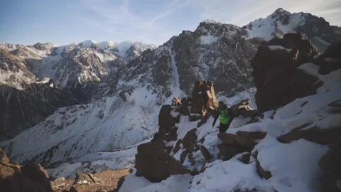 Man running at the mountain with snow Stock Footage 168373266