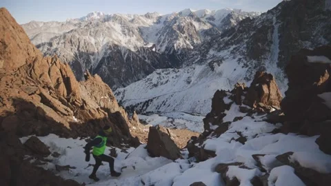 Man running at the mountain with snow Stock Footage 168373363