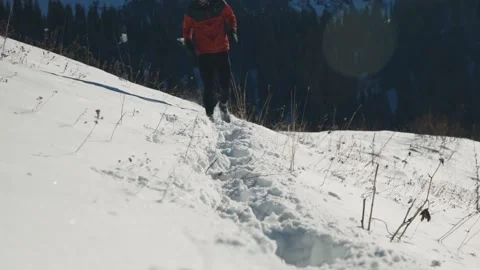 Man running at the mountain with snow Stock Footage 169927523