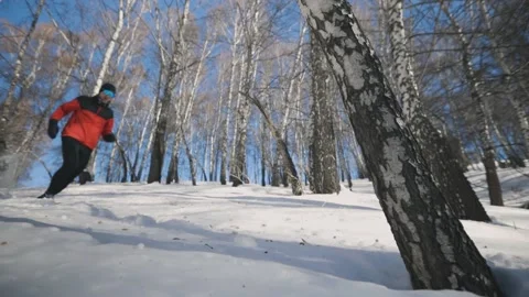 Man running at the mountain with snow Stock Footage 169927693