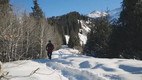 Man running at the mountain with snow Stock Footage 169928607