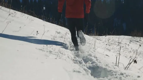 Man running at the mountain with snow Stock Footage 169930360