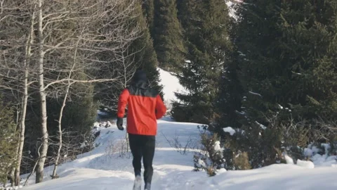 Man running at the mountain with snow Stock Footage 170428301