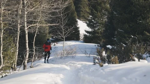 Man running at the mountain with snow Stock Footage 170428436