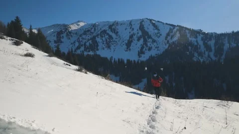 Man running at the mountain with snow Stock Footage 170436354