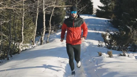 Man running at the mountain with snow Stock Footage 170436408