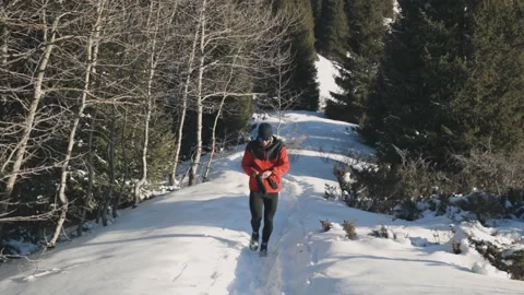 Man running at the mountain with snow Stock Footage 170650060