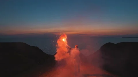 The man running on the mountain top with a fire stick in his hands. slow motion Vídeos de archivo 144041697