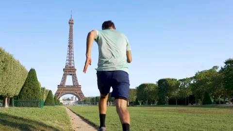 Man running next to the Eiffel tower Stock Footage 249202138