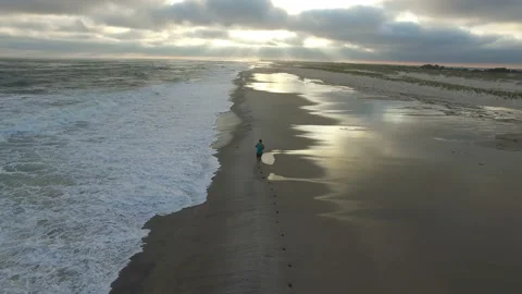 Man Running On Ocean Beach, Look at Smart Watch Stock Footage 101855456