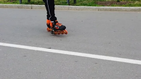 Man running on orange rollers in valea morilor park, slow motion close up Stock Footage 112864780