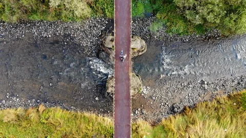 Man running over small bridge Stock Footage 95540784