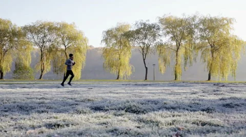 Man running at park during cold autumn morning Stock Footage 57819065