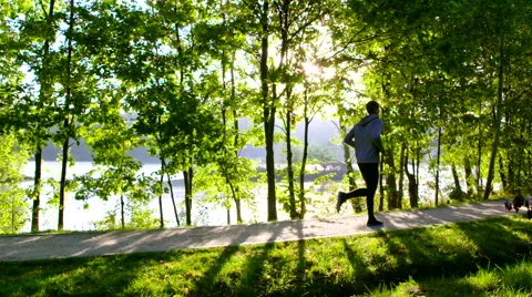 Man running in park during sun rise – slow motion 動画素材 55084883