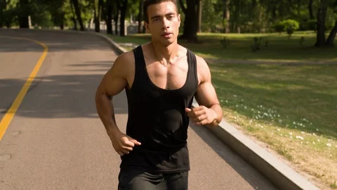 Man running in Park Follow Medium closeup shot Stock Footage 112143562