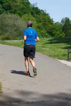 Man running in a park Stock Photos