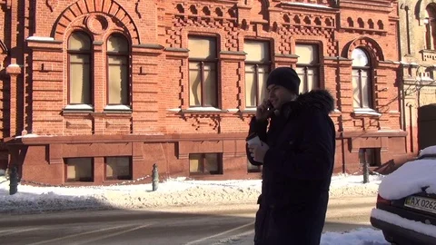 Man running in the park at winter time and talking on cellphone Stock Footage 74227678