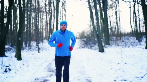 Man running on the path at winter, steadycam shot, slow motion shot Stock Footage 46887861