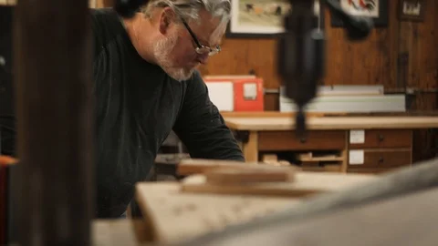Man running piece of wood through machine Stock Footage 102045375