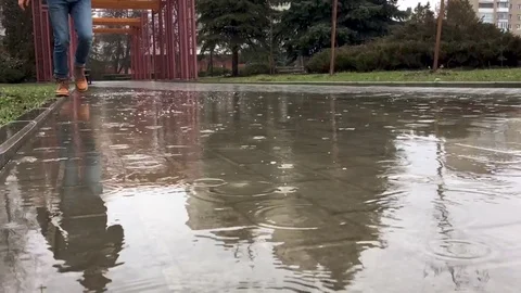 A man running on a puddle Stock Footage 94761299
