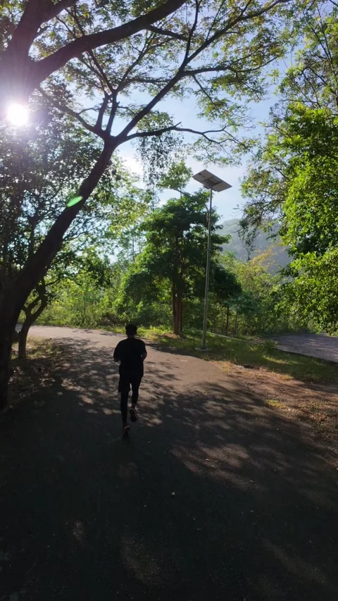 Man Running on Road in Nature Stock Footage 335460322