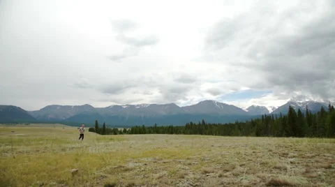 Man running on a rural road during sunset in the mountains Stock Footage 65483989