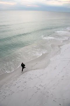 Man running by the seashore Stock Photos