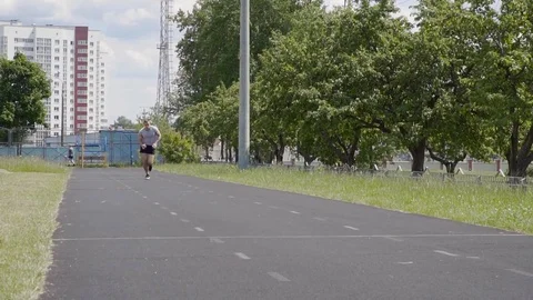 The man is running sprint on the stadium. Training outdoors. Slow motion Stock Footage 77718031