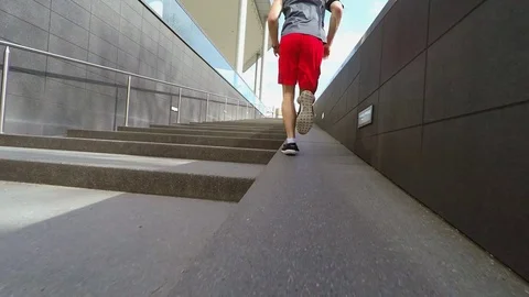 Man running by stairs Stock Footage