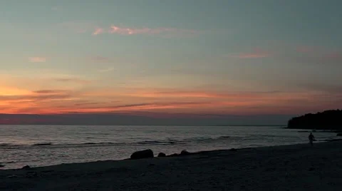 Man running at sunset at the beach Stock Footage 68984788