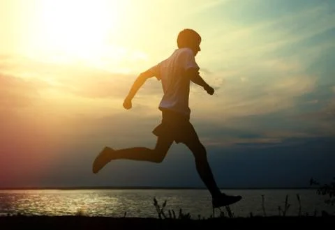 Man running at Sunset Foto stock