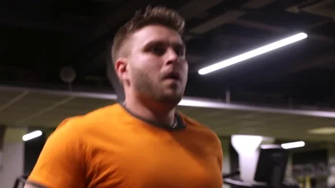 Man running on thread mill at gym Stock Footage 83129033