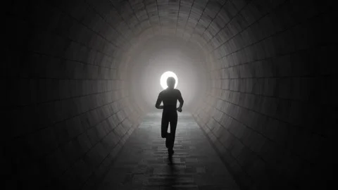 Man running through a brick tunnel towards the light - 3D illustration Stock Footage 246788993